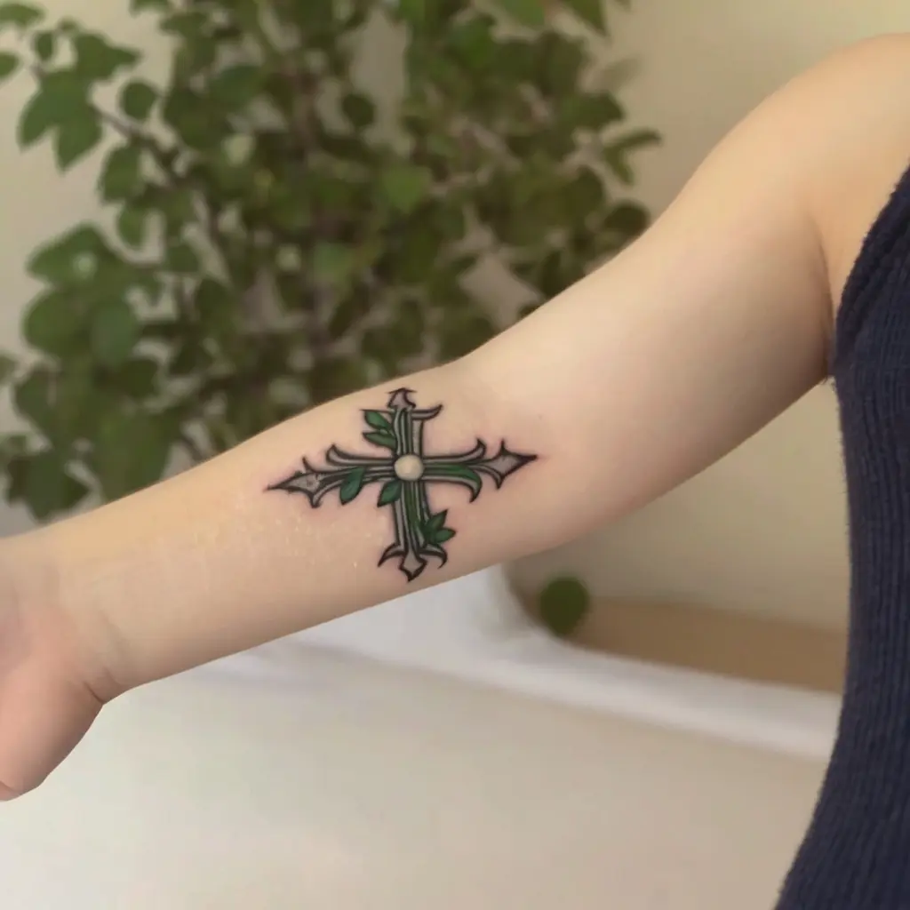 Floral and Nature-Inspired Tiny Cross Tattoo 2